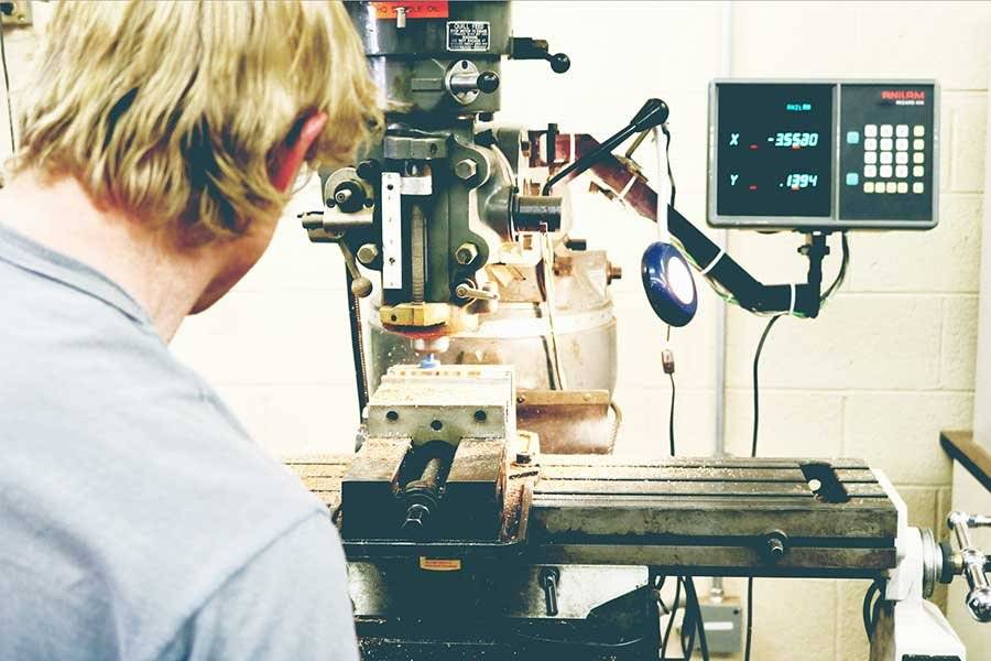 Man watching milling machine at work