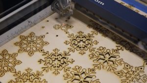 laser cutter cutting out snowflakes