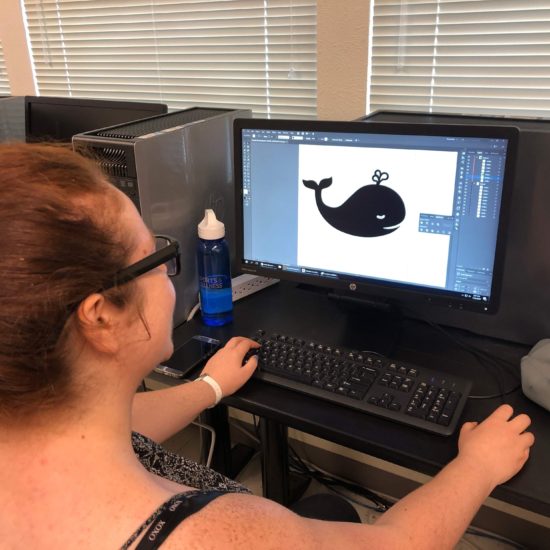 Image of a member drawing a vector shape in Illustrator