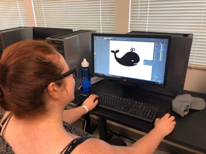 Image of a member drawing a vector shape in Illustrator