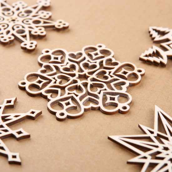An image showing 5 wooden ornaments that were cut on a lasercutter