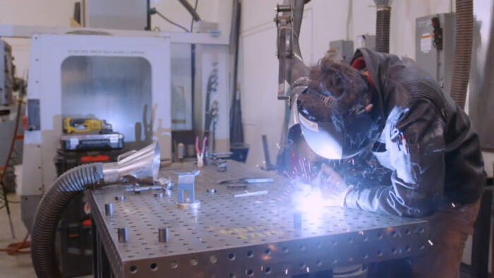 a person welding a metal surface