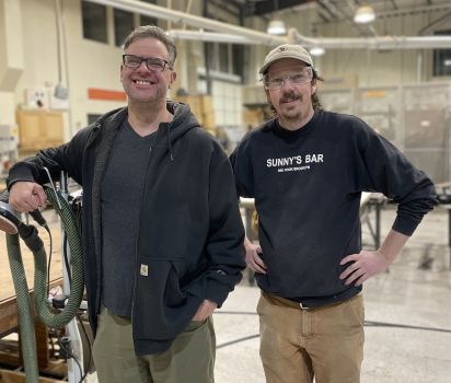 FUSE's woodshop instructors standing in the shop.