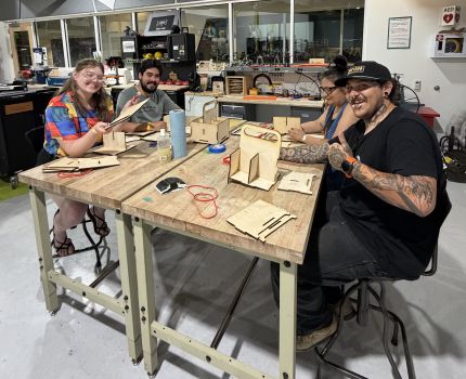 People assemble beer caddies as part of a FUSE workshop at Explora's Science of Beer Night.